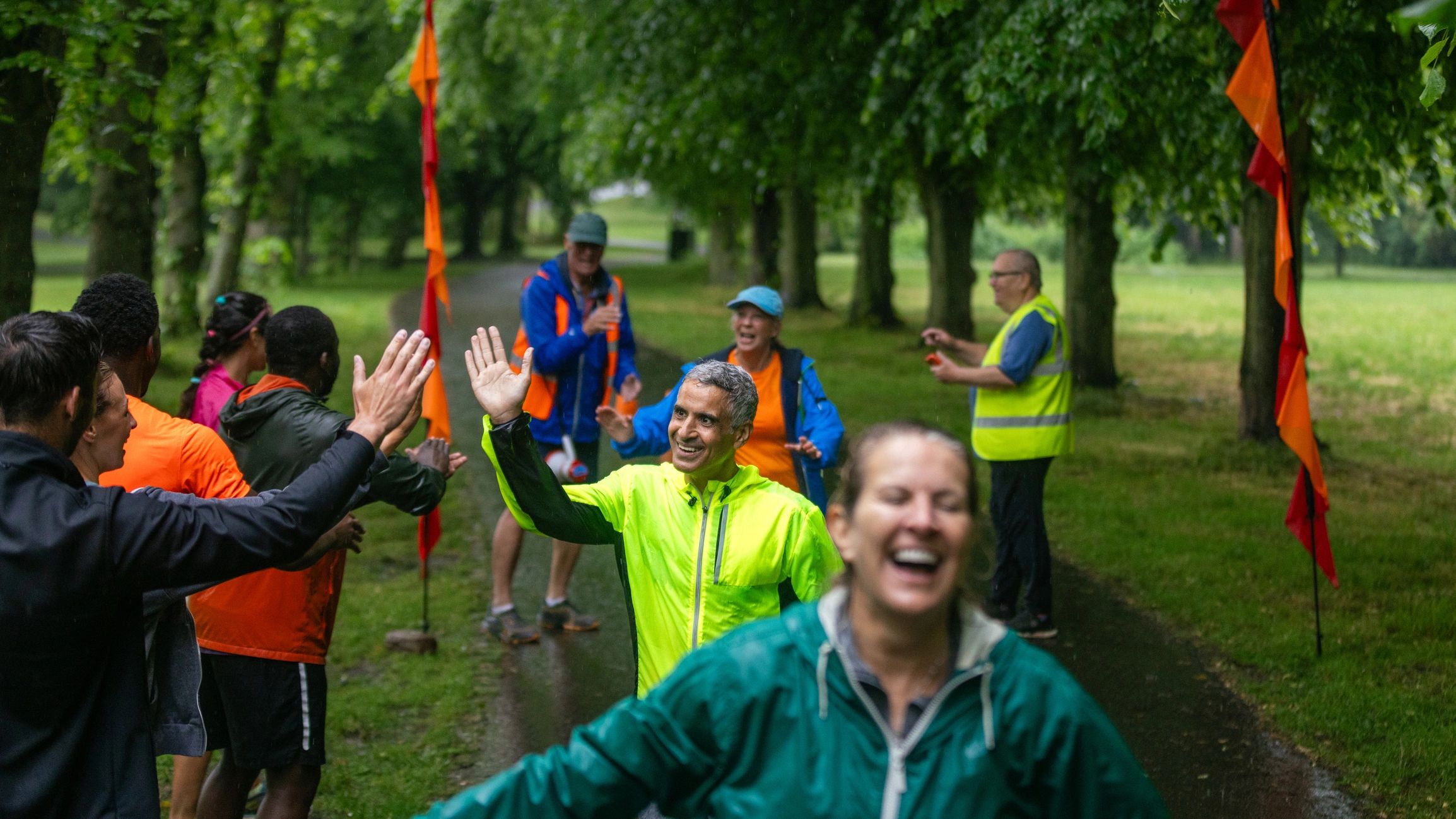 Community members celebrating at an outdoor event finish line